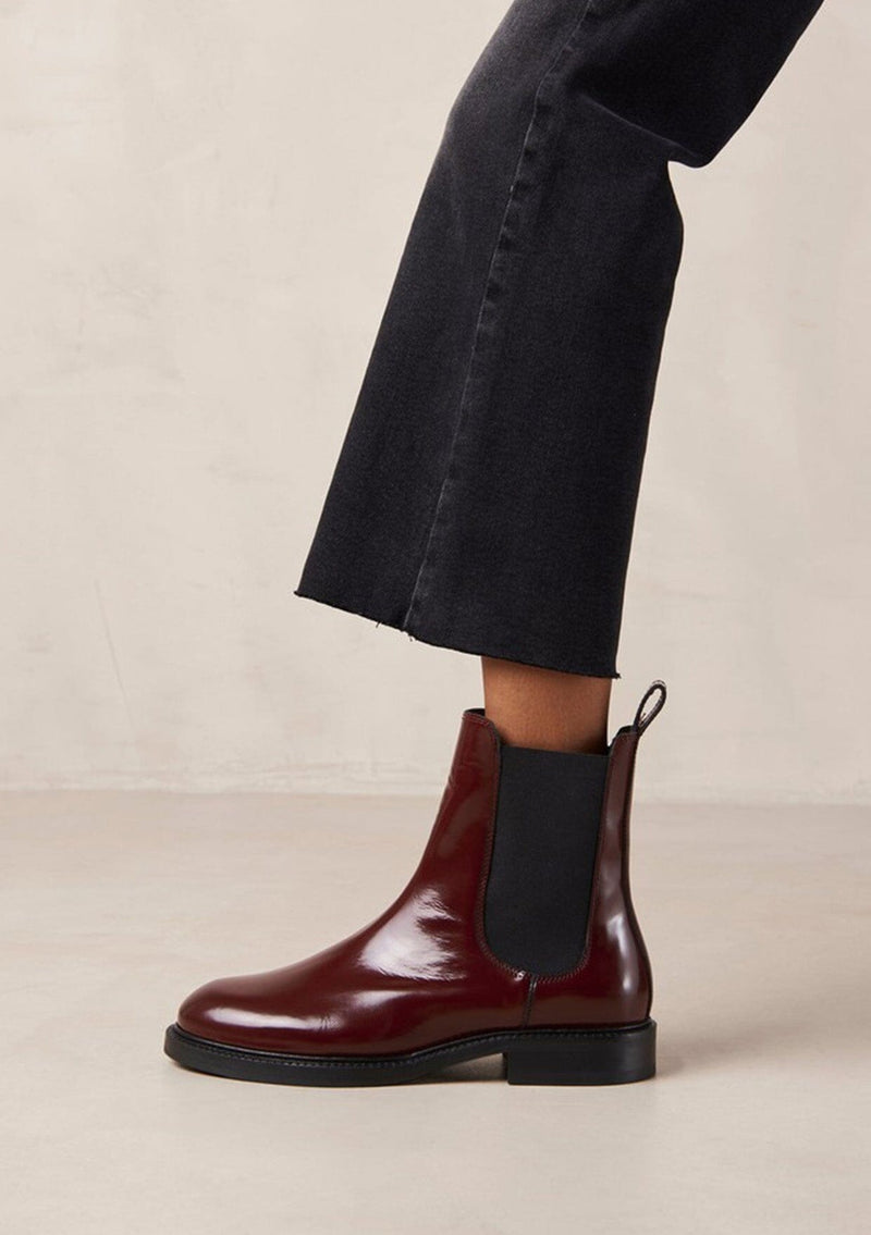 [Color: Burgundy] An elevated version of a classic chelsea boot crafted in red leather with a glossy finish. with elastic gores, thick rubber soles, and pull tab. A perfect trendy boot for the fall season. Designed by Alohas in Spain and Portugal.