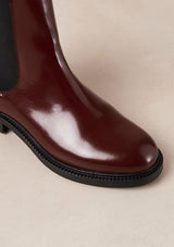 [Color: Burgundy] An elevated version of a classic chelsea boot crafted in red leather with a glossy finish. with elastic gores, thick rubber soles, and pull tab. A perfect trendy boot for the fall season. Designed by Alohas in Spain and Portugal.