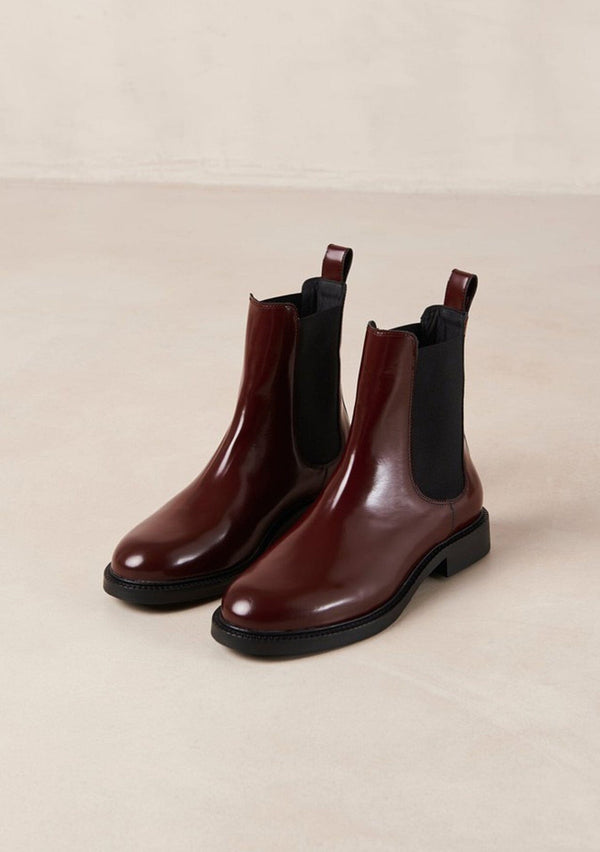 [Color: Burgundy] An elevated version of a classic chelsea boot crafted in red leather with a glossy finish. with elastic gores, thick rubber soles, and pull tab. A perfect trendy boot for the fall season. Designed by Alohas in Spain and Portugal. 