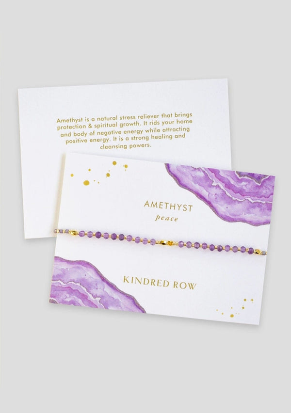 [Color: Amethyst] An adjustable healing bracelet, crafted on a durable nylon cord with gold-plated hardware and purple natural gemstones. Designed by Kindred Row.