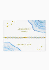 [Color: Aquamarine] An adjustable healing bracelet, crafted on a durable nylon cord with gold-plated hardware and blue natural gemstones. Designed by Kindred Row.