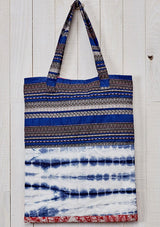 [Color: Blue Multi] A bohemian blue patchwork print tote bag with hanging tassel accent. 