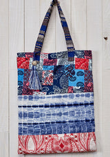 [Color: Blue Multi] A bohemian blue patchwork print tote bag with hanging tassel accent. 