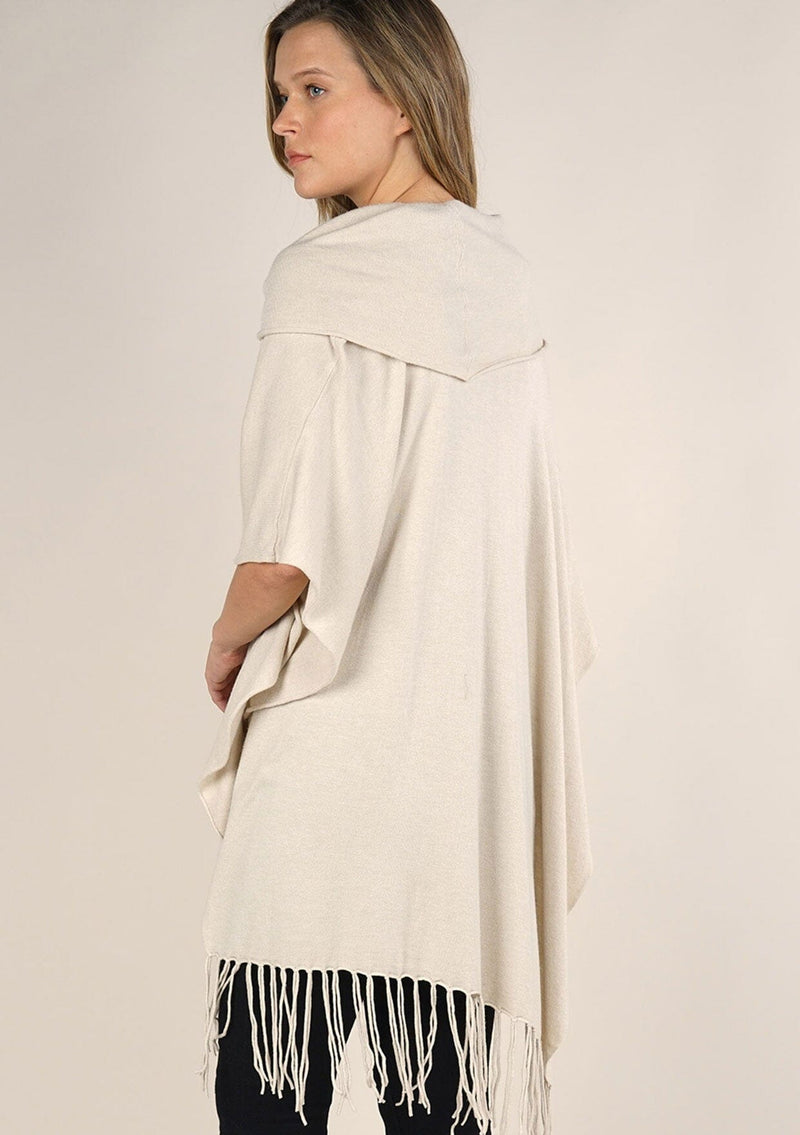 [Color: Bone] A classic bohemian fringed sweater poncho with oversized cowl neckline. 