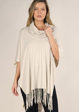 [Color: Bone] A classic bohemian fringed sweater poncho with oversized cowl neckline. 