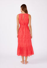 [Color: Coral] A brunette woman wearing a bright coral midi dress with embroidered eyelet details. With a sleeveless design, v neckline, adjustable waist belt, open back with button closure, and a ruffle trimmed hem.