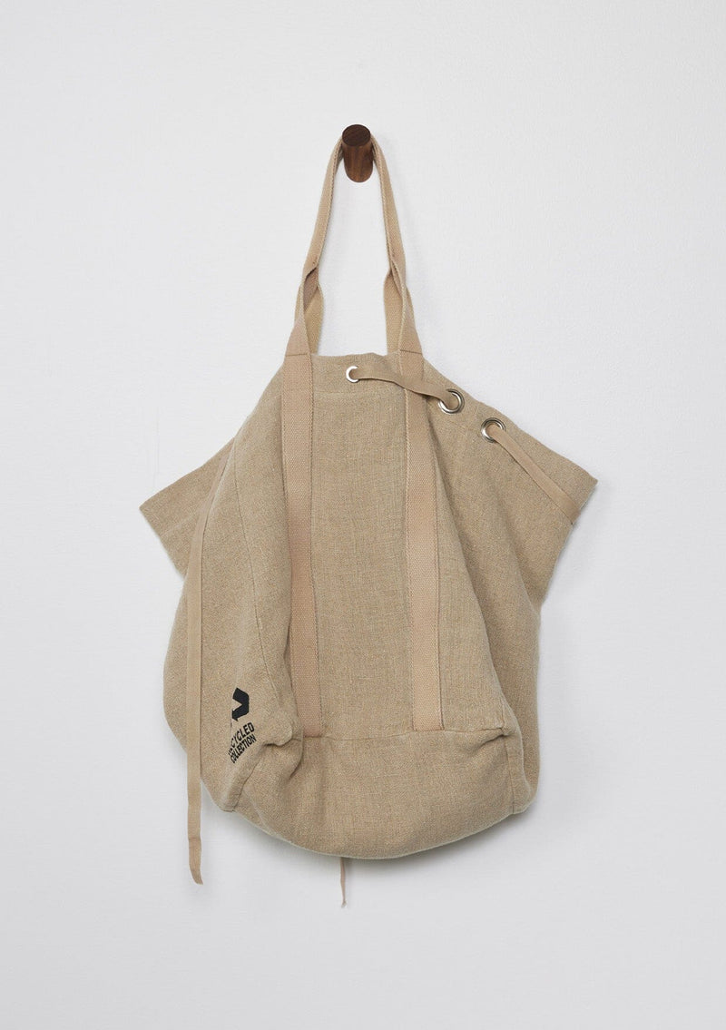 [Color: Natural/Mauve/Marigold] A reversible bohemian tote bag with double top handles, oversized grommets, an attached pouch with zip closure, and a tie closure.