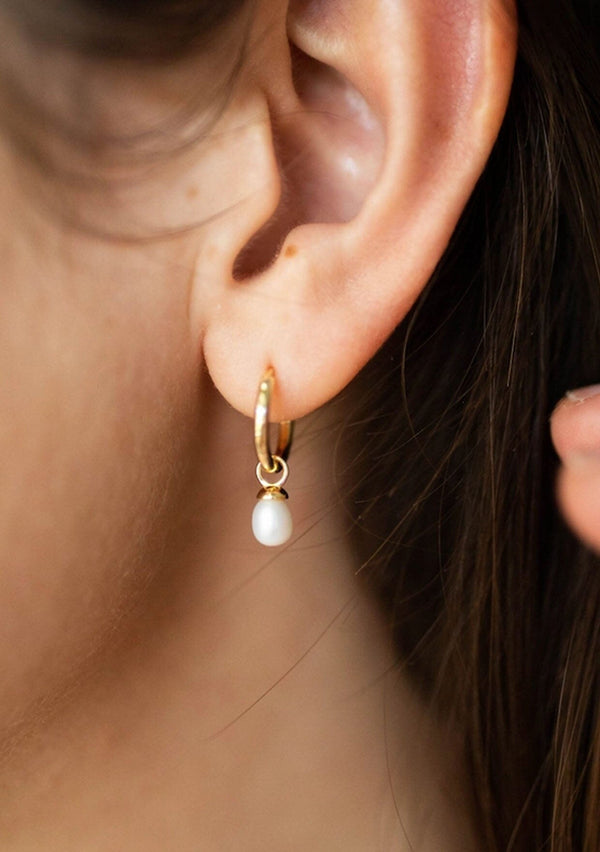  [Color: Gold] A delicate gold-plated hoop earring with an oval charm crafted from mother of pearl. The hoop is hypoallergenic, made with fourteen karat gold plated sterling silver.  Designed by the salty gem. 