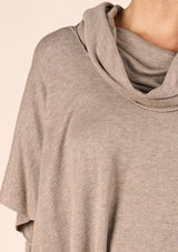 [Color: Heather Grain] A classic bohemian fringed sweater poncho with oversized cowl neckline. 