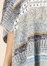 [Color: Grey/Blue] A lightweight bohemian sweater poncho pullover top in a mixed stripe. With short sleeves, a v neckline, and a relaxed fit. 