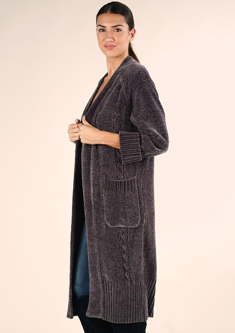 [Color: Charcoal] A side facing image of a brunette model wearing a soft grey chenille knit duster cardigan. With long sleeves, an open front, and side pockets. 