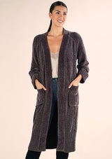 [Color: Charcoal] A front facing image of a brunette model wearing a soft grey chenille knit duster cardigan. With long sleeves, an open front, and side pockets. 