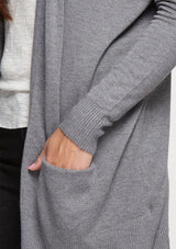 [Color: Heather Charcoal] A soft knit grey cardigan with an open front, a hoodie, and two side pockets. 