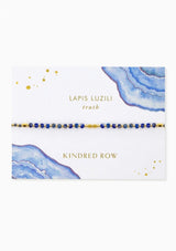 [Color: Lapis Lapis Lazuli] An adjustable healing bracelet, crafted on a durable nylon cord with gold-plated hardware and blue gemstones. Designed by Kindred Row.