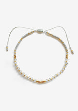 [Color: Labradorite] An adjustable healing bracelet, crafted on a durable nylon cord with gold-plated hardware and clear grey natural gemstones. Designed by Kindred Row.