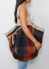 [Color: Natural/Rust/Navy] A reversible bohemian tote bag with double top handles, oversized grommets, an attached pouch with zip closure, and a tie closure. 