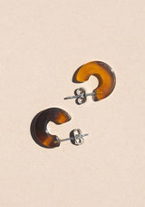 [Color: Hazel] A small brown acetate hoop earring. 