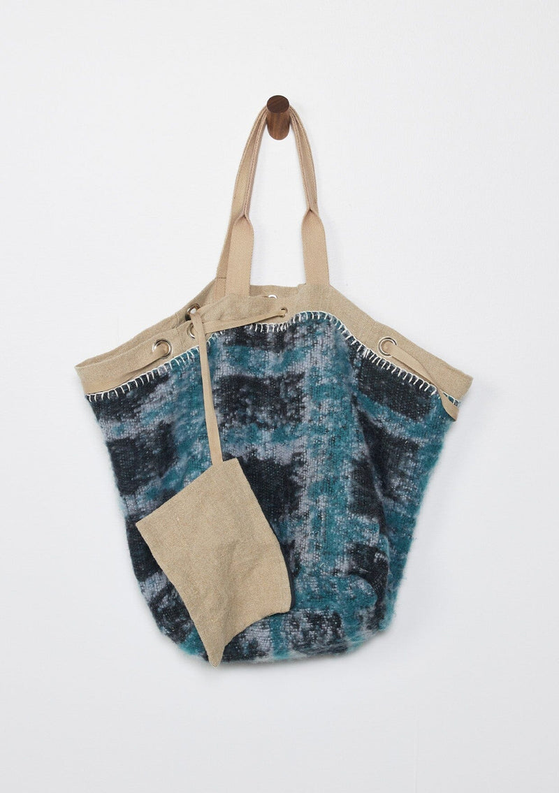 [Color: Natural/Black/Teal] A reversible bohemian tote bag with double top handles, oversized grommets, an attached pouch with zip closure, and a tie closure. 