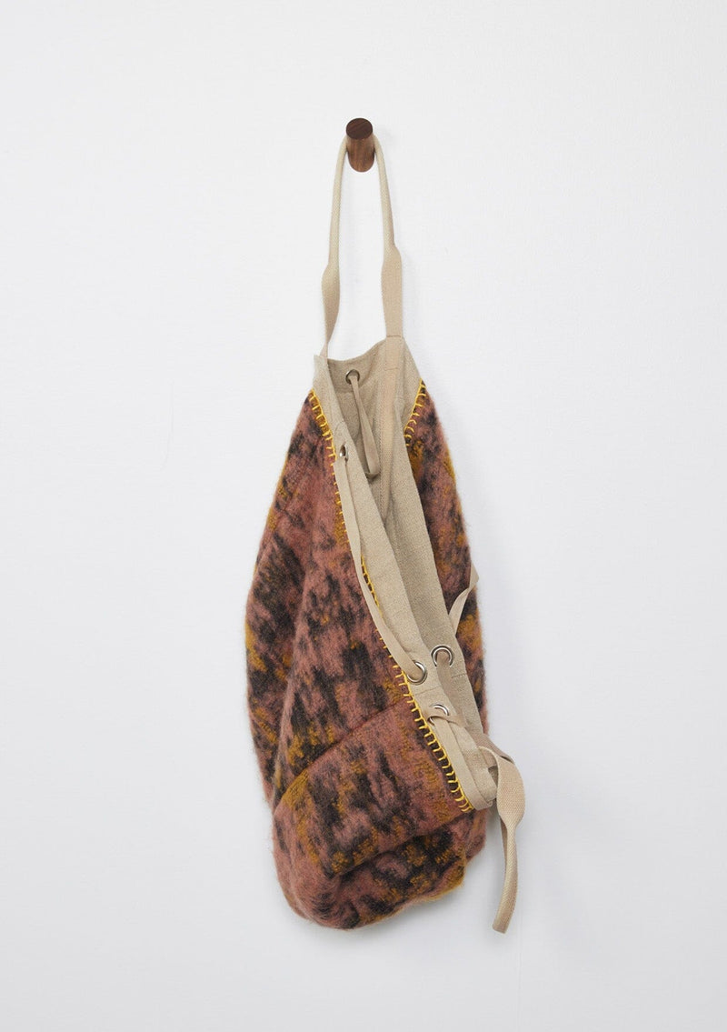 [Color: Natural/Mauve/Marigold] A reversible bohemian tote bag with double top handles, oversized grommets, an attached pouch with zip closure, and a tie closure. 