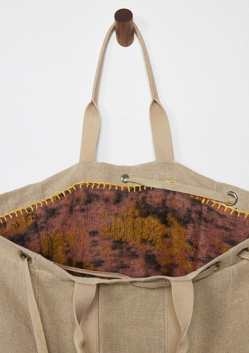 [Color: Natural/Mauve/Marigold] A reversible bohemian tote bag with double top handles, oversized grommets, an attached pouch with zip closure, and a tie closure. 