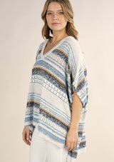 [Color: Oatmeal/Blue] A lightweight bohemian sweater poncho pullover top in a mixed stripe. With short sleeves, a v neckline, and a relaxed fit. 