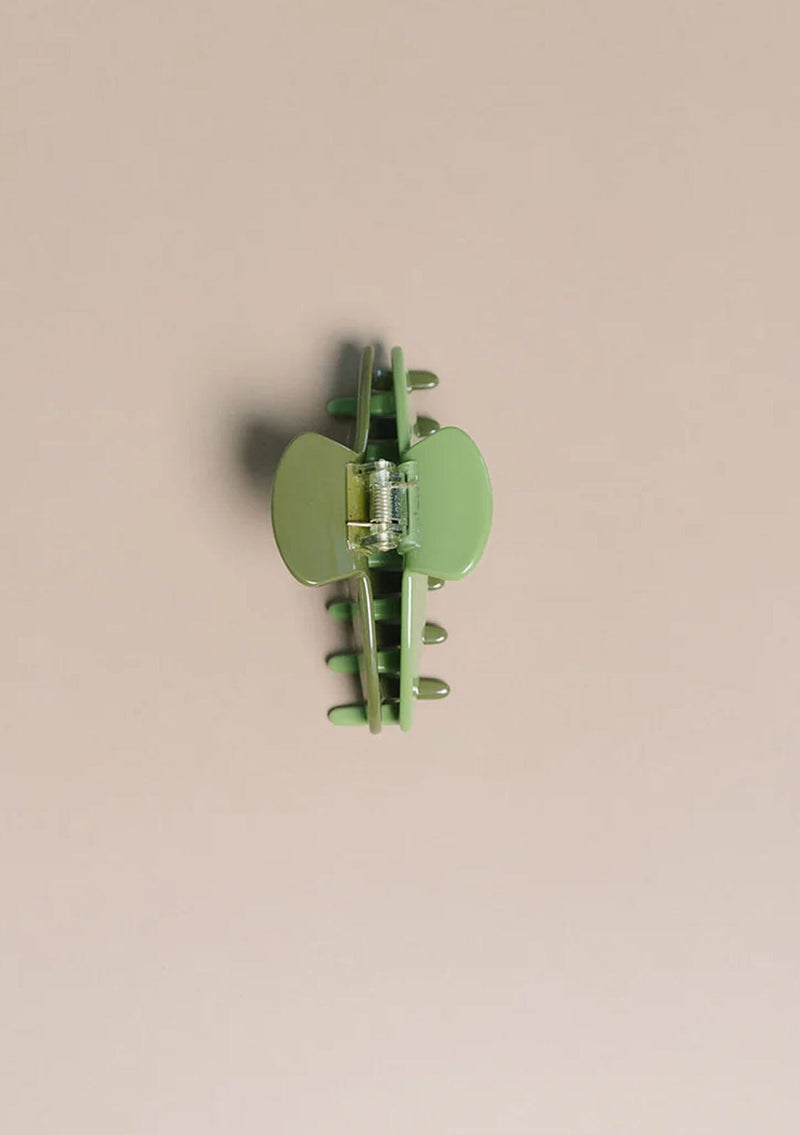 [Color: Pear] A two tone green medium sized hair clip by Nat and Noor. 