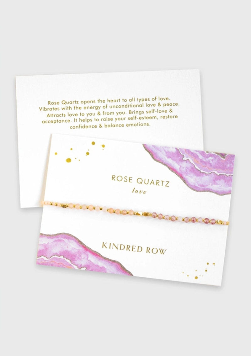 [Color: Rose Quartz] An adjustable healing bracelet, crafted on a durable nylon cord with gold-plated hardware and pink natural gemstones. Designed by Kindred Row.