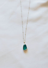 [Color: Blue] A white gold plated sterling silver base necklace with a unique sea glass charm in white.