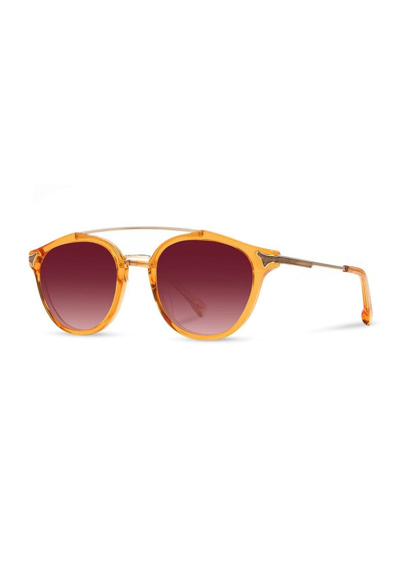 [Color: Tangerine] Clear Italian acetate sunglasses with contemporary round lens, metal brow bar, and wood accents. Orange frame accent with an ombre pink lenses. 