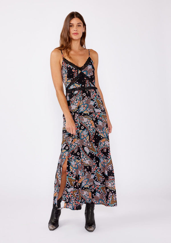 [Color: Black/Light Blue] A brunette model wearing a multi color floral print maxi dress with a flirty lace trim. An edgy bohemian maxi dress with a flattering v neckline, adjustable spaghetti straps, smocked back, and side slits. A sleeveless dress perfectly paired with boots or flats for the summer to fall season. 