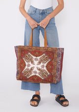 [Color: Pink/Yellow/Natural] A multi colored bohemian cotton tote bag with suede leather top handles and beaded details. 