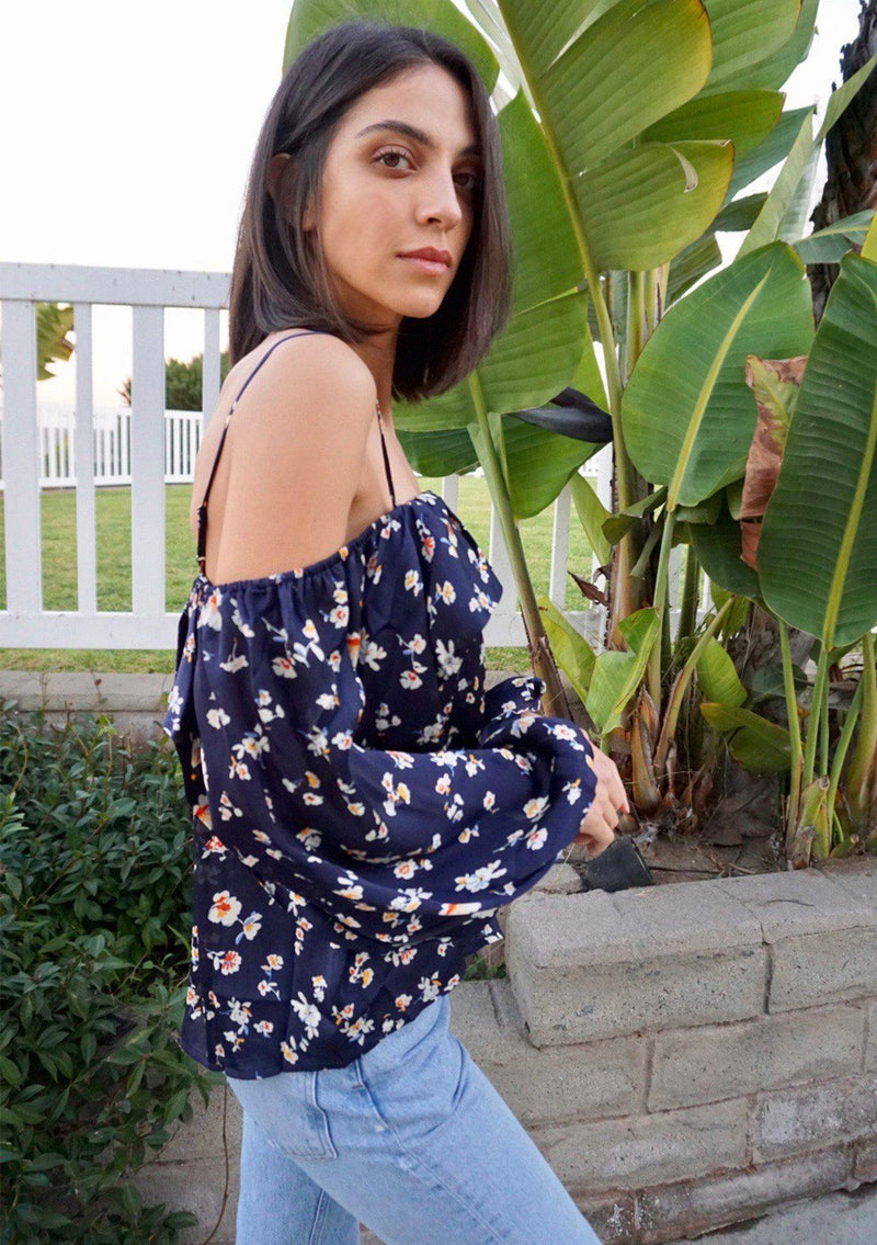 [Color: Midnight] A soft and silky bohemian cold shoulder top in a pretty small floral print. Featuring an off shoulder flounce detail, adjustable spaghetti straps, and flattering voluminous long sleeves. 