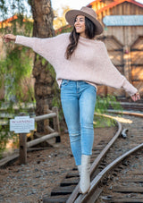 [Color: Petal] Our buttery soft fuzzy sweater features a versatile boat neckline and flattering long dolman sleeves. This cozy pullover is styled off shoulder with denim.