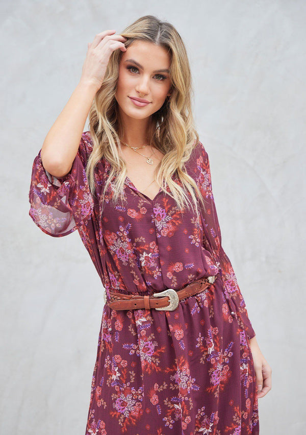 [Color: Wine Spice] A bohemian maxi dress in pretty mixed florals. Featuring a split v neckline with ties, a cinched elastic waist, and long bell sleeves with a split cuff.