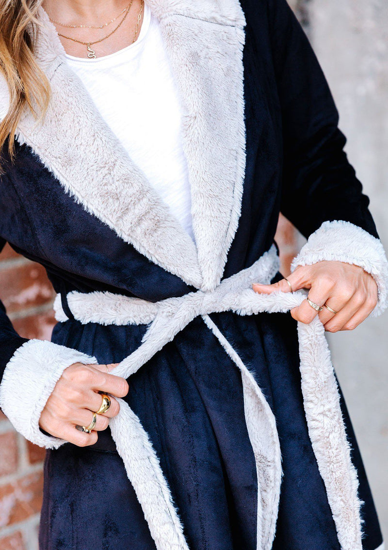 [Color: Black Oat] A faux shearling coat in vegan suede. Featuring a cozy faux shearling interior and trim, a waist defining self tie belt, and essential side pockets. This timeless style is worn here with denim for a chic Fall look.