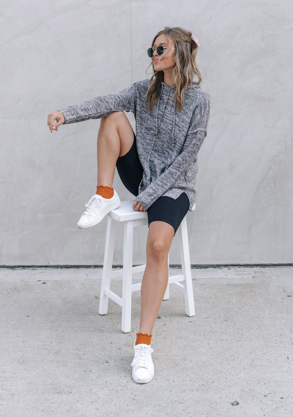 [Color: Charcoal] The quintessential California style pullover. This soft sweater in beautiful neutral tones features a drawstring hoodie, breezy side vents, and exposed seams throughout.