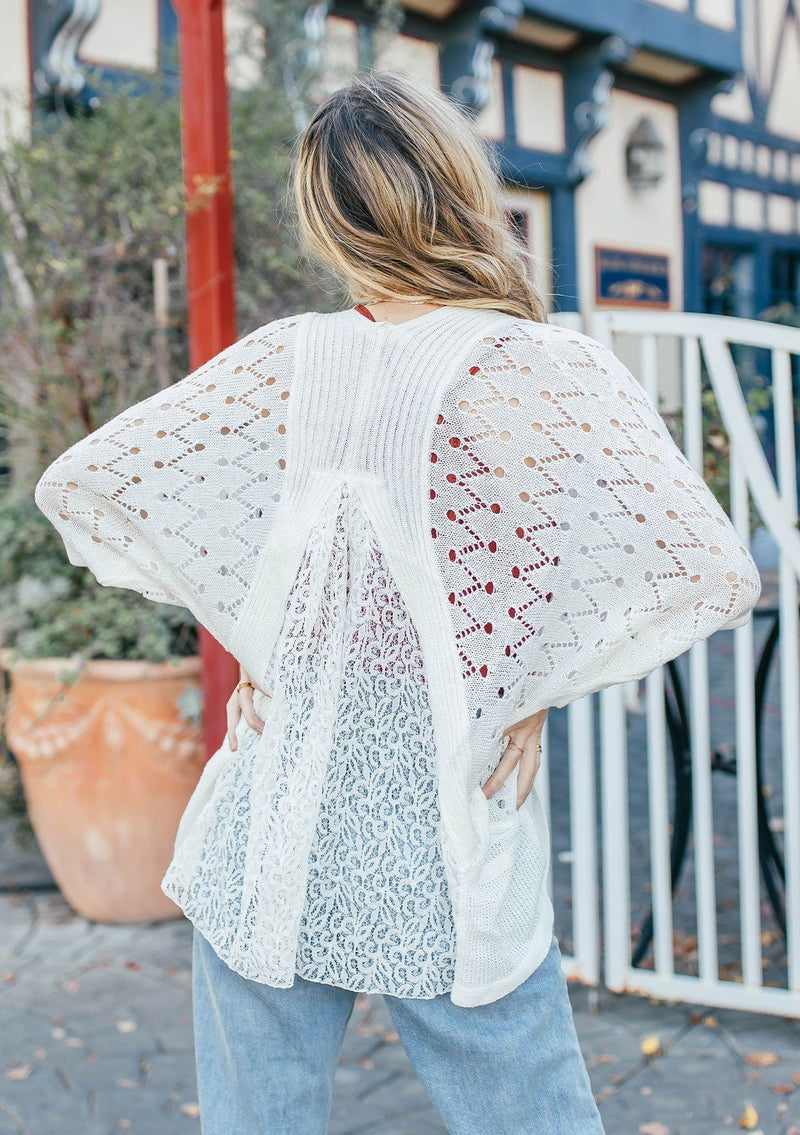 [Color: Off White] Girl wearing a white crochet short sleeve cocoon cardigan.