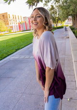 [Color: Lavender] A blond woman wearing an Ombre tie dye sweater top. Features a scooped neckline, breezy side vents and front pockets. 