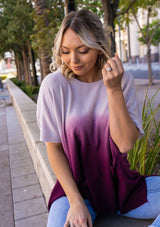 [Color: Lavender] A blond woman wearing an Ombre tie dye sweater top. Features a scooped neckline, breezy side vents and front pockets. 