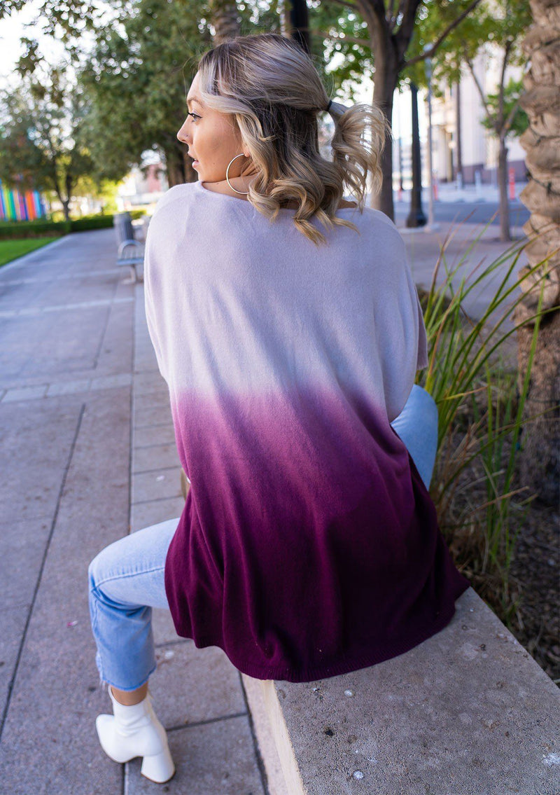 [Color: Lavender] A blond woman wearing an Ombre tie dye sweater top. Features a scooped neckline, breezy side vents and front pockets. 