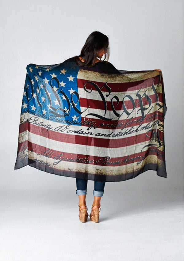 [Color: Flag] We are bringing this beautiful American Flag scarf back just when you need it most! A beautiful and chic, lightweight red, white and blue scarf with We the People printed on top. Slight distressed details add a bohemian touch. This beautiful scarf doubles as a fashionable face mask. Quarantine in style and keep yourself and others safe and healthy!