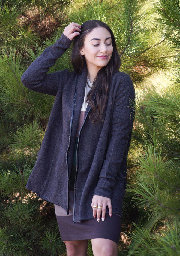 [Color: Charcoal] A cozy cardigan sweater, featuring essential side pockets and a chic vegan faux leather trim. 