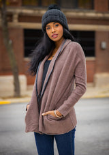 [Color: Mahogany] A cozy cardigan sweater, featuring essential side pockets and a chic vegan faux leather trim. 