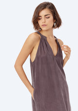 [Color: Charcoal] A brunette model wearing a cupro maxi dress with a split v-neckline, side pockets, and side slits. 