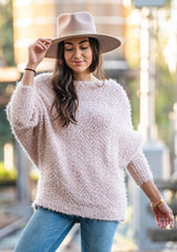 [Color: Petal] Our buttery soft fuzzy sweater features a versatile boat neckline and flattering long dolman sleeves. This cozy pullover is styled off shoulder with denim.