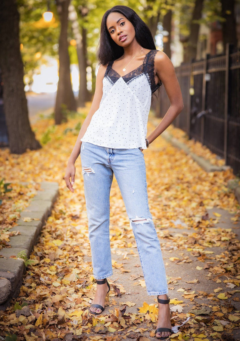 [Color: White Black] A lace trim camisole in an allover polka dot print. Featuring a delicate lace trim v neckline in front and a v neckline in back, lace straps, and a relaxed draped silhouette. 