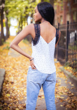 [Color: White Black] A lace trim camisole in an allover polka dot print. Featuring a delicate lace trim v neckline in front and a v neckline in back, lace straps, and a relaxed draped silhouette. 