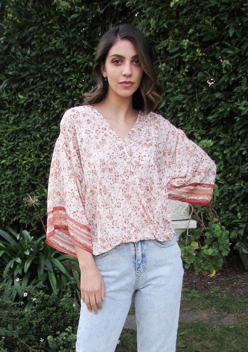 [Color: Brick/Ivory] Girl wearing a floral bohemian surplice top with kimono sleeves. 