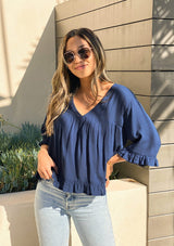 [Color: Dark Denim] Girl wearing a beautiful flowy cropped half sleeve ruffled blouse.