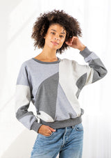 [Color: Heather Grey Combo] A model wearing a classic French terry sweatshirt in a trendy patchwork panel design. With a crew neckline and a contrast ribbed trim. 